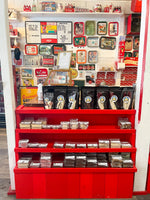 A red and white display shelf filled with Lucky Duck Fudge products and retro diner decor within Ice Dreams Soda Shop.