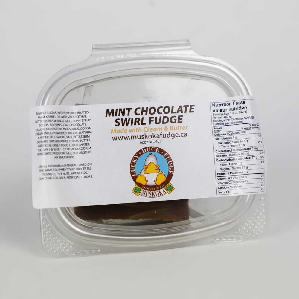 A quarter pound portion of Mint Chocolate Swirl Fudge by Lucky Duck Fudge in a clear plastic tub and a label on the lid with the ingredients and nutritional facts.